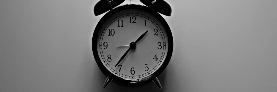 white bell alarm clock with black frame