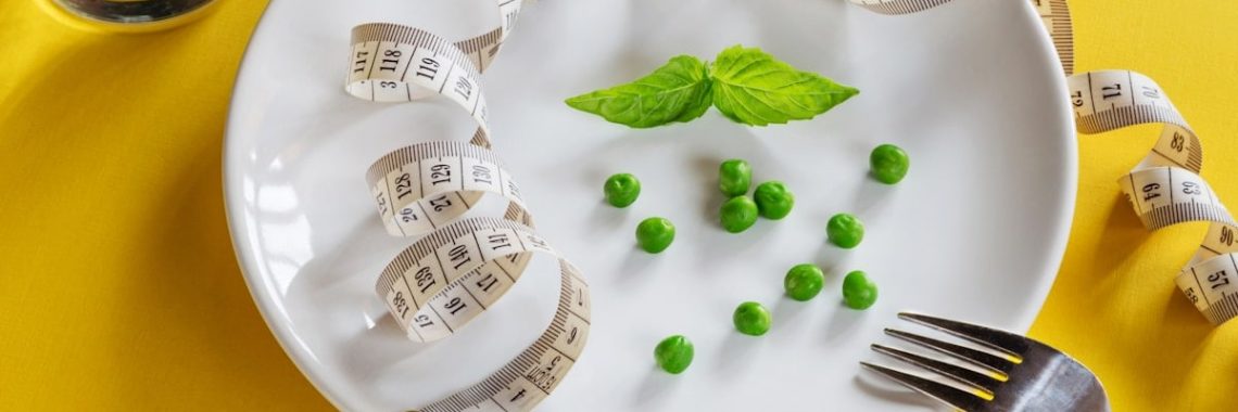 Diet white plate with centimeter peas and basil